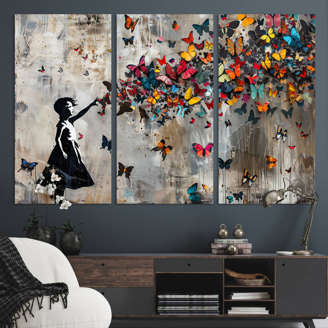 The Banksy Butterfly Girl 3-Piece Modern Graffiti Canvas Wall Art features a silhouette of a girl reaching for butterflies.