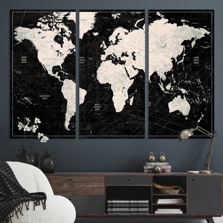 A bold global style framed black and white world map canvas print, presented in three panels, perfect for modern home or office decor.