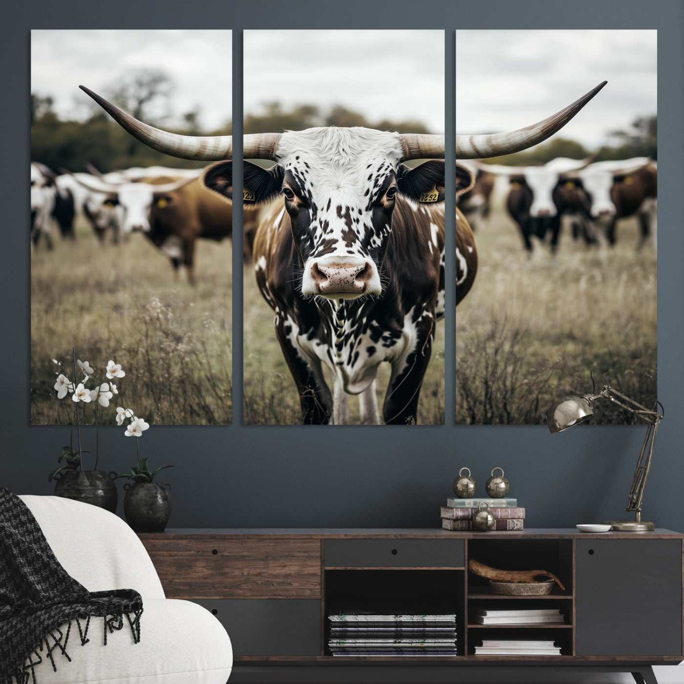 Canvas of a speckled Texas longhorn standing boldly in a field with a herd behind, perfect for rustic western or farmhouse wall decor.