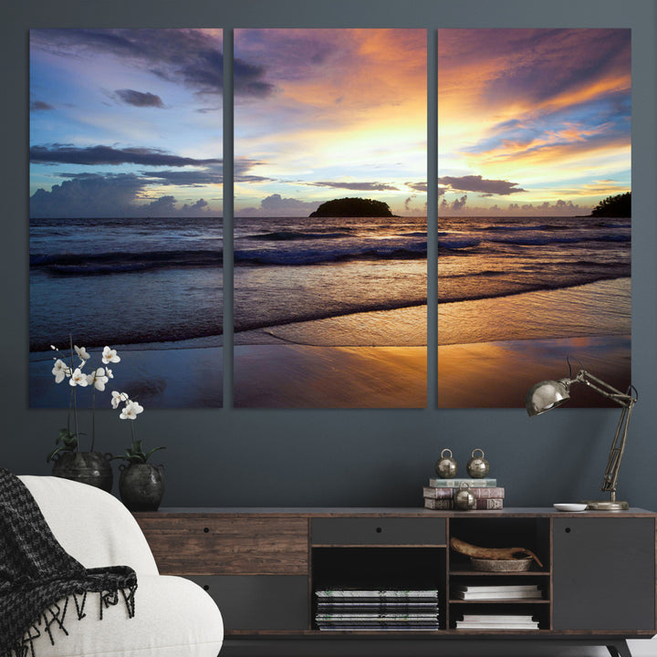 A tropical beach at sunset with waves gently washing ashore, reflecting golden and purple hues in the sky, creating a tranquil coastal scene.