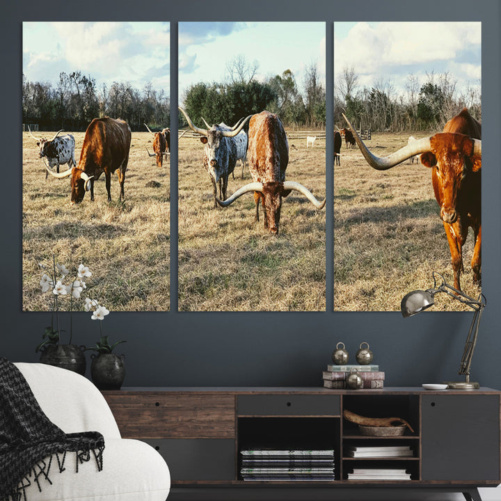 A herd of Texas Longhorn cattle grazing in an open field under a partly cloudy sky, capturing a rustic and Western ranch aesthetic.