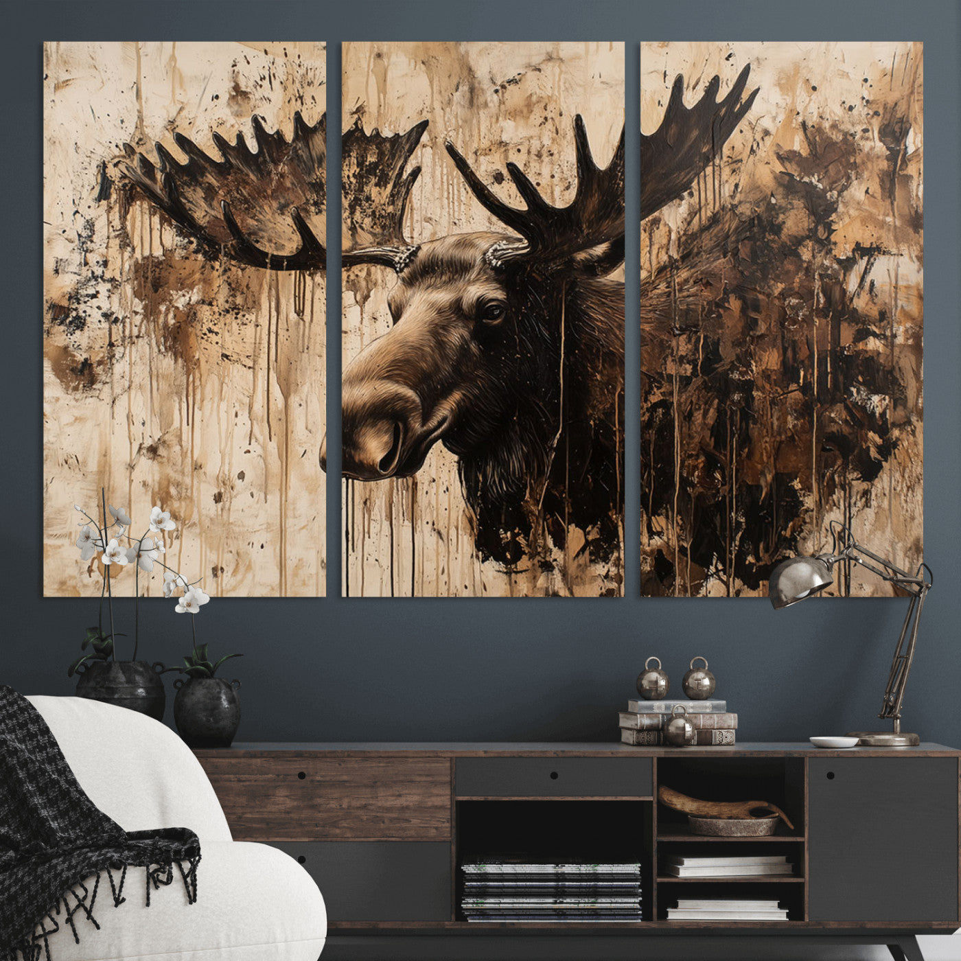 Artistic painting of a moose head with large antlers in shades of brown and black, with paint splatters and drips on a beige textured background, creating a rustic and expressive wall art canvas.