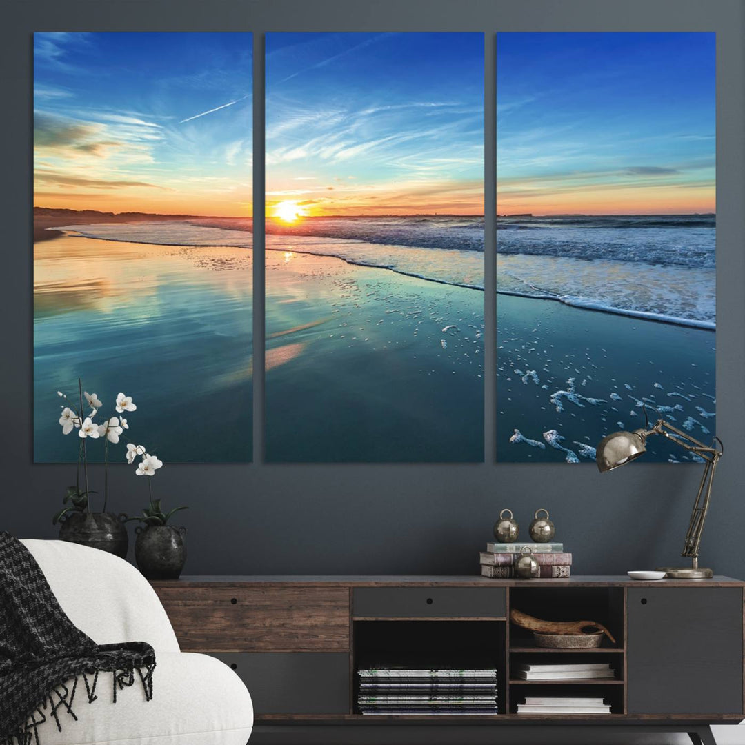 The Blue Sky and Beach Wall Art Canvas Print features a vibrant orange sky reflecting on wet sand.