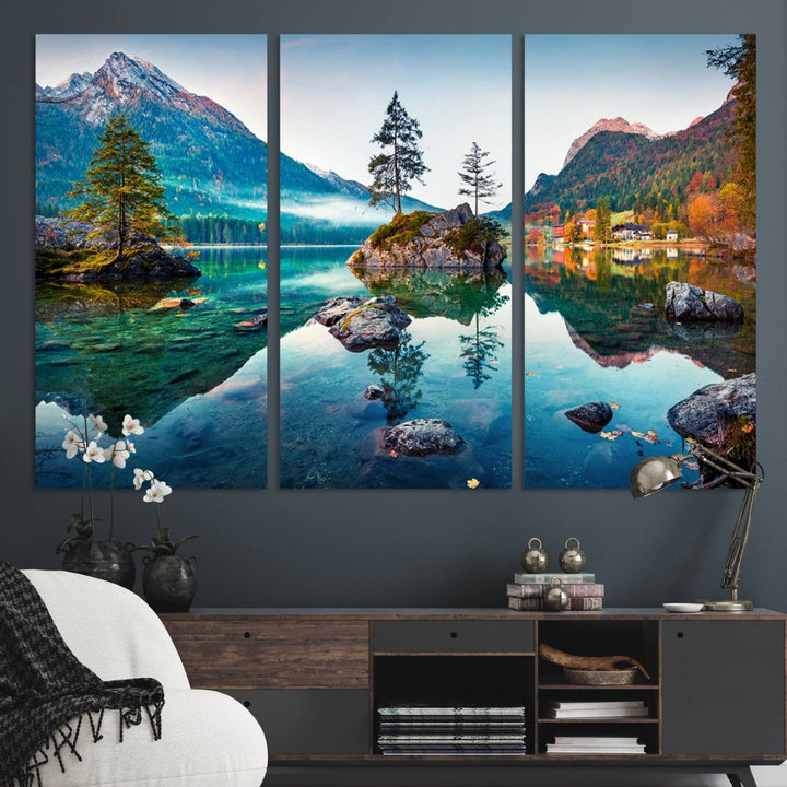 The 3-panel wall art showcases a serene mountain lake with rocky islands and trees, creating an ideal focal point for dining rooms or offices.