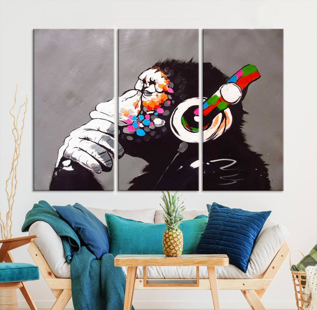 A vibrant triptych, the "DJ Monkey Listening to Music" wall art print, features a Banksy-inspired large canvas adorned with colorful modern pop art. This striking piece elegantly enhances the room with its dynamic and lively depiction.