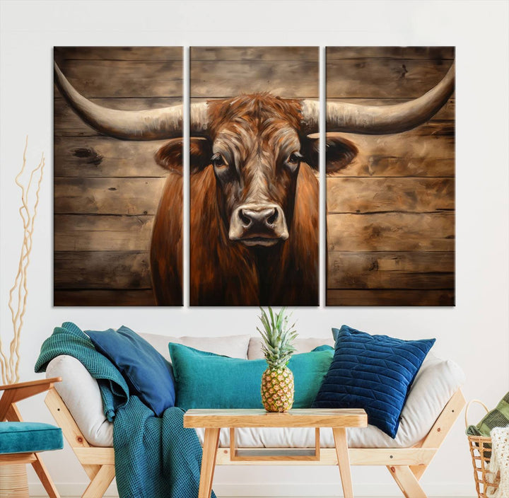 The Longhorn Bull Wall Art, a ready-to-hang canvas print, showcases an image of a brown longhorn cow set against a wooden background, perfect for those looking to enhance their space with rustic farmhouse and western barn decor.