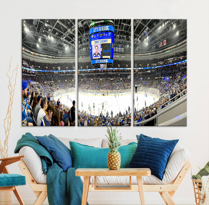 Wall art prints depicting the bustling scenes of the St. Louis Blues being cheered on by a full house at the Enterprise Center, beneath a large scoreboard.