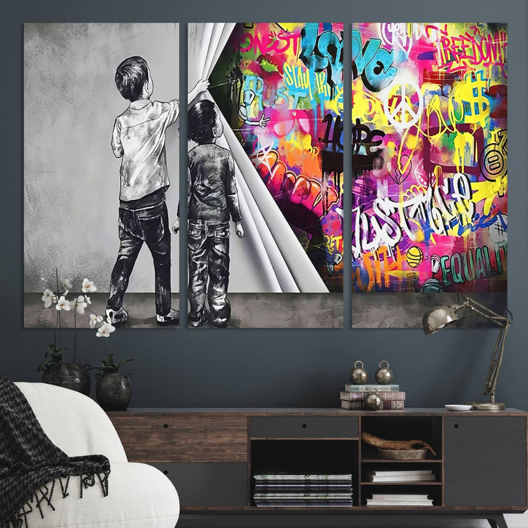 The Banksy Print - Street Art Canvas features a vibrant and bold image of two children lifting a curtain to reveal colorful graffiti. It's ready to hang, adding an urban modern decor vibe.