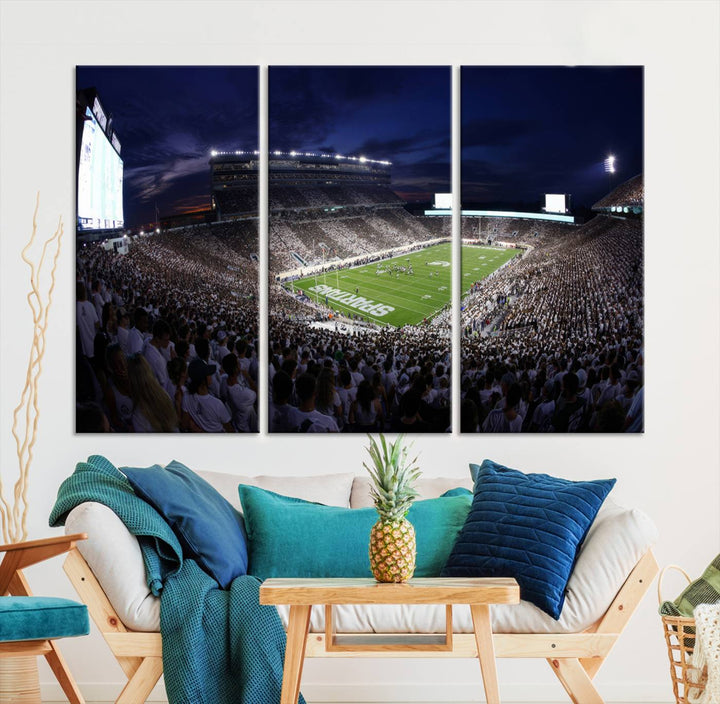 A packed football stadium at night, with bright lights and fans in white, depicted in a Michigan State Spartans Stadium wall art.