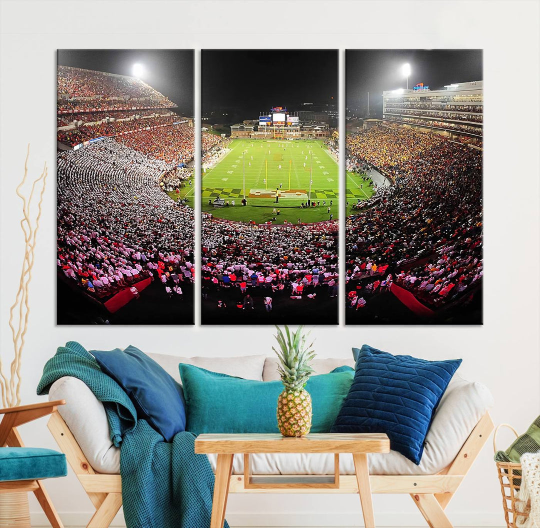 The Maryland Terrapins Football Wall Art Canvas showcases a packed SECU Stadium at night with a bright field and cheering fans.