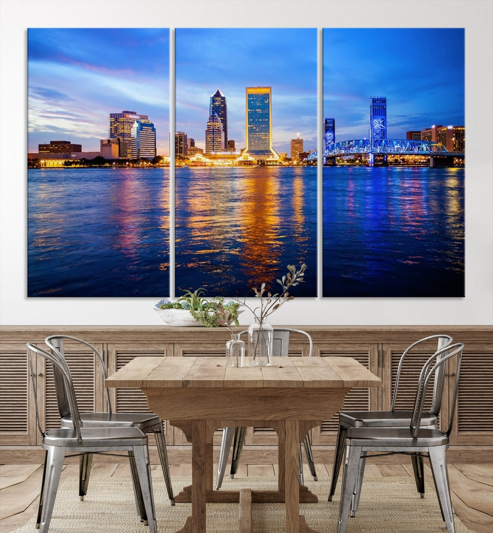 A cozy living room features the Jacksonville Wall Art Canvas Print, a large triptych crafted on museum-quality canvas that beautifully depicts the Jacksonville city skyline at sunset.