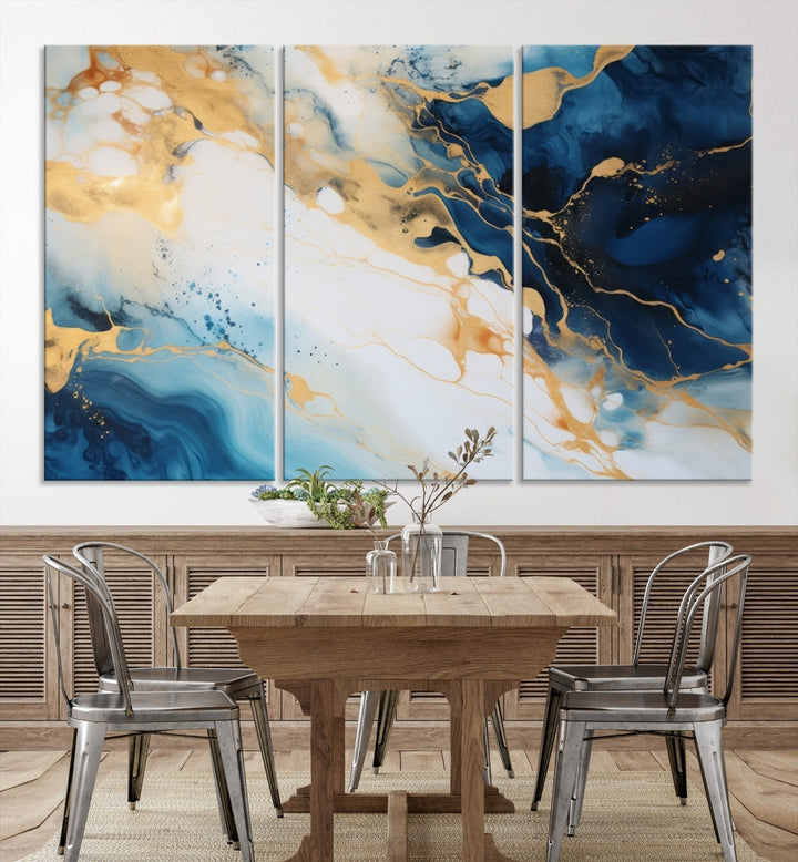 A modern living room featuring museum-quality Blue Gold Abstract Wall Art Print Contemporary art in a triptych arrangement.