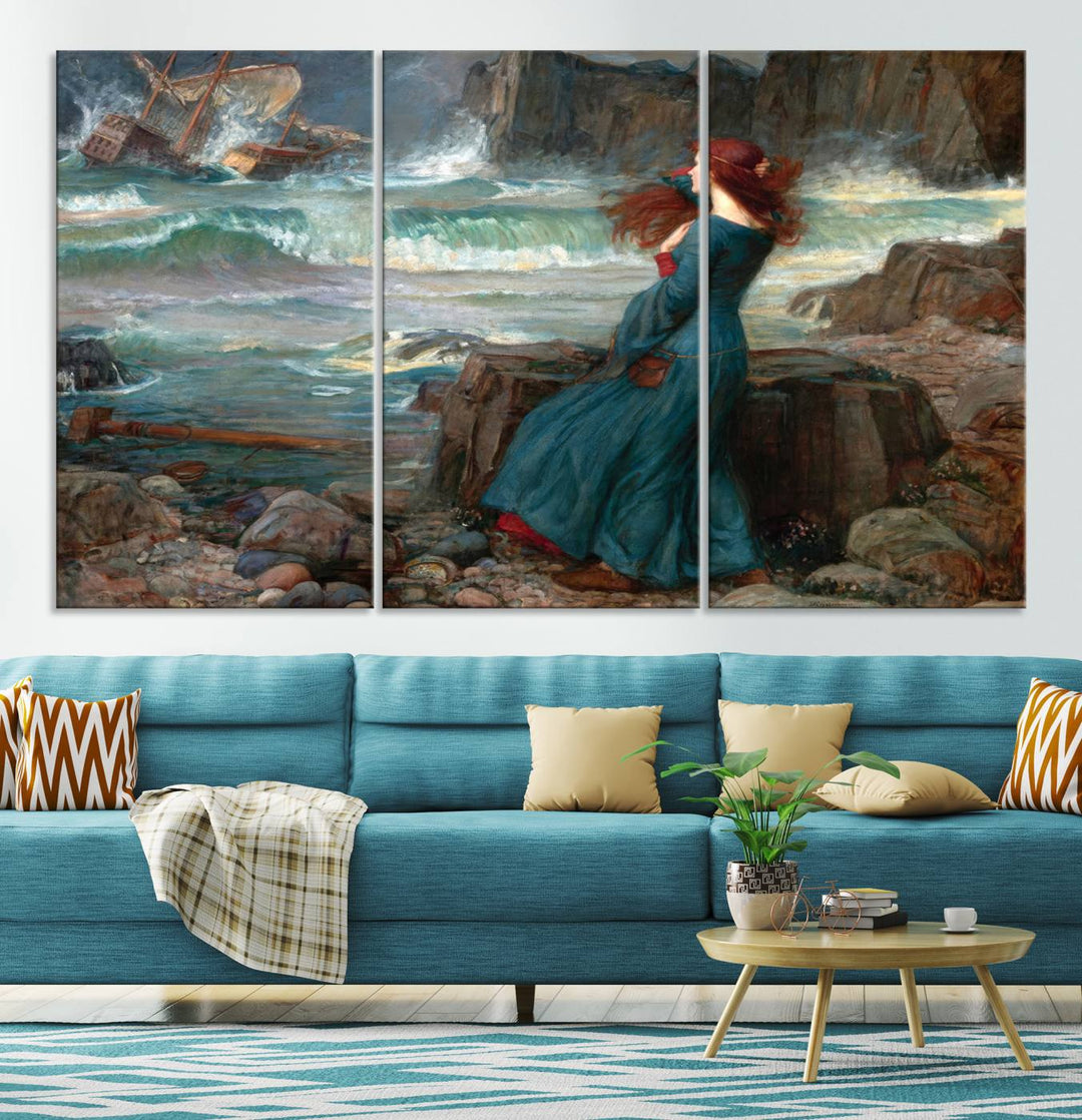 The Miranda by the Shore Wall Art Canvas Print depicts a woman in a blue dress standing by the sea, watching a shipwreck.