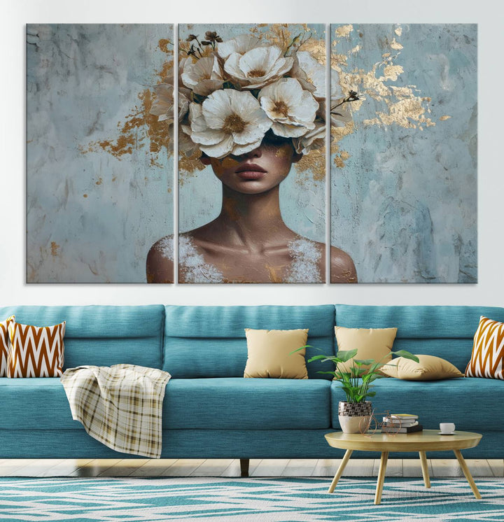 The Golden Petal Silhouette Woman Wall Art Canvas Print, a large 3-panel canvas with a textured gold floral design, serves as a luxurious centerpiece in modern glam settings. The artwork depicts a woman with flowers over her eyes against a textured background and hangs elegantly.