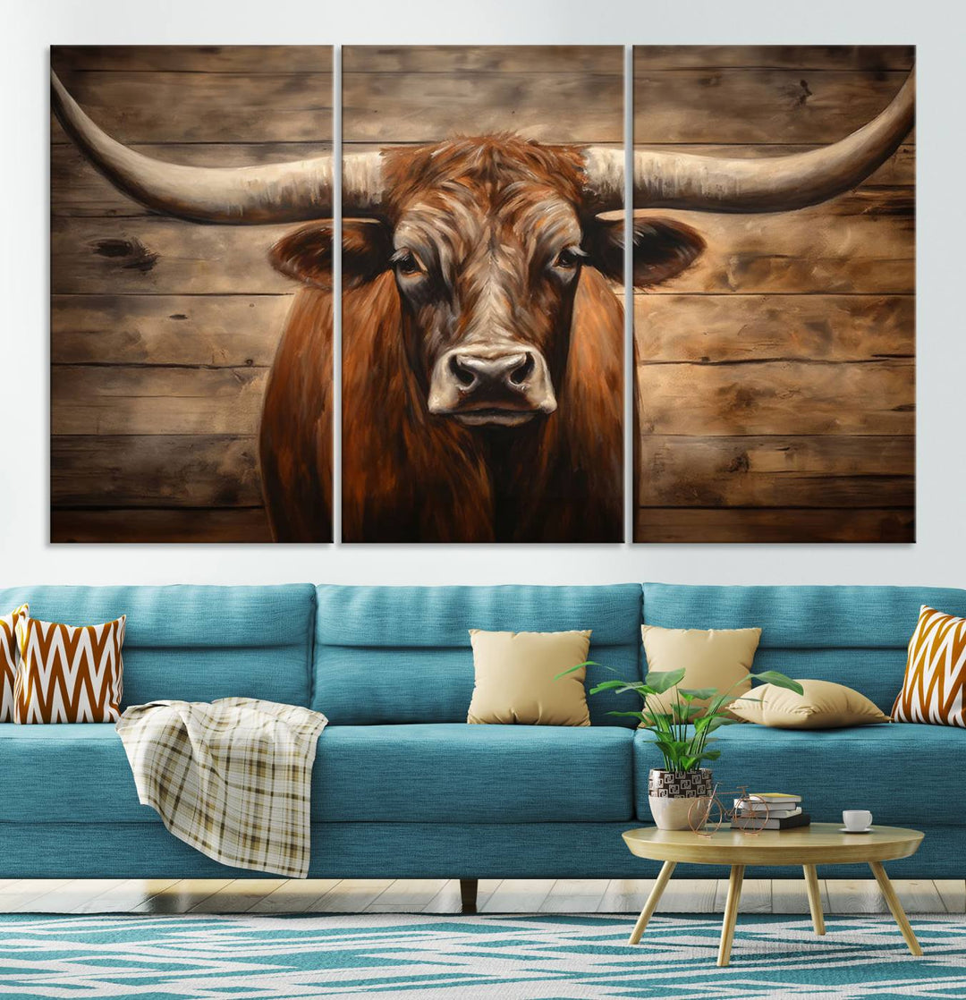 The Longhorn Bull Wall Art, a ready-to-hang canvas print, showcases an image of a brown longhorn cow set against a wooden background, perfect for those looking to enhance their space with rustic farmhouse and western barn decor.