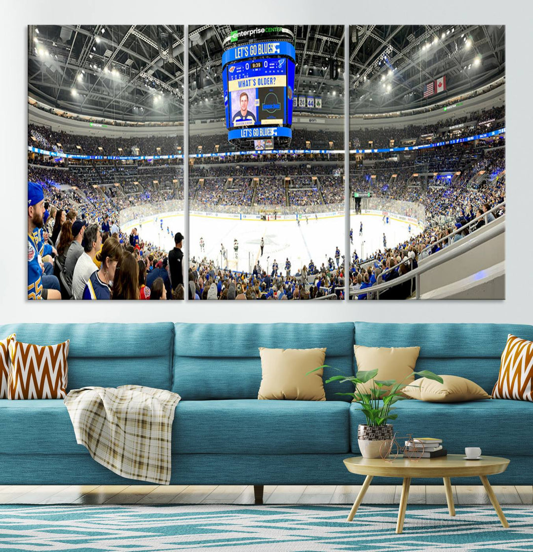 Wall art prints depicting the bustling scenes of the St. Louis Blues being cheered on by a full house at the Enterprise Center, beneath a large scoreboard.