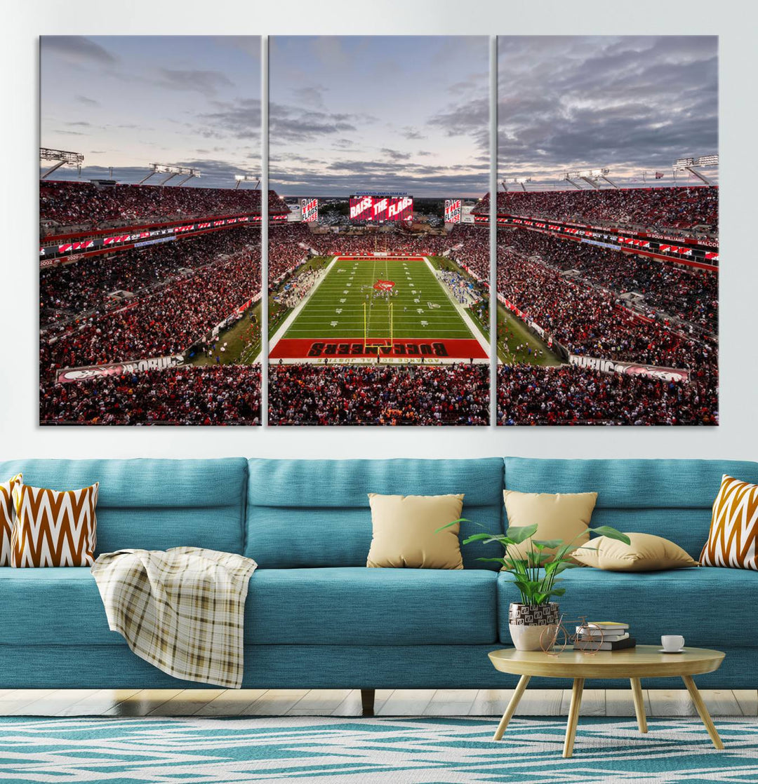 The wall art captures a stunning scene of Raymond James Stadium bathed in the warm hues of sunset. The sky, filled with clouds, provides a dramatic contrast to the vibrant lighting on the field, encapsulating the dynamic energy of a football game.