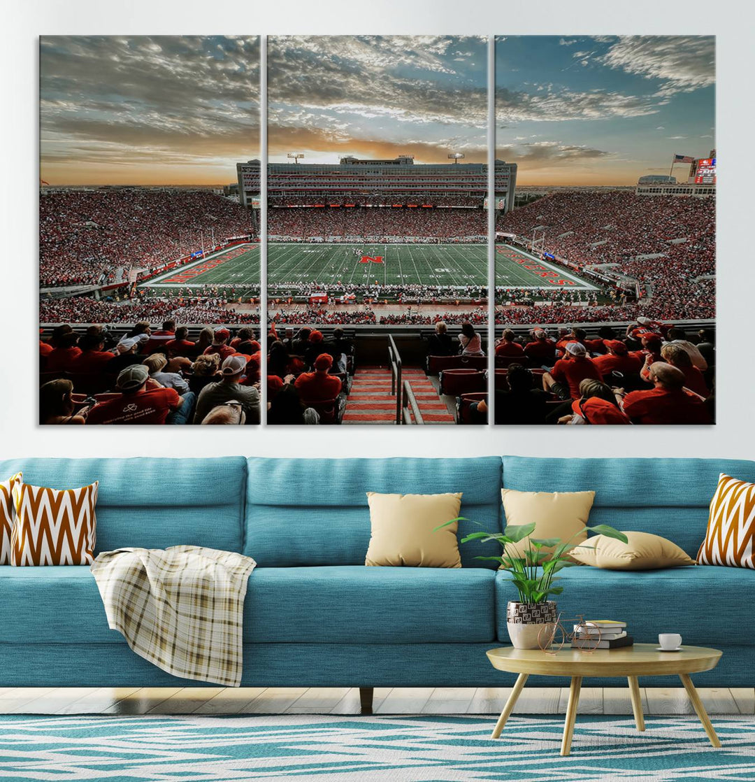 The living room features a stunning triptych of Lincoln Memorial Stadium wall art canvas print, celebrating the University of Nebraska Cornhuskers football team. This piece serves as captivating wall art, showcasing a gallery-quality finish.