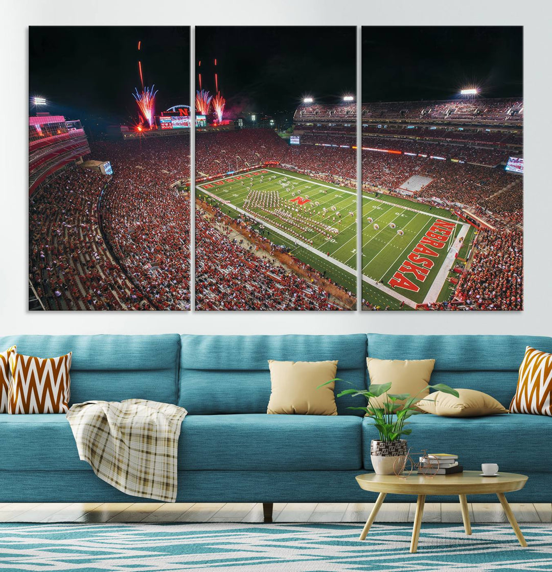 The University of Nebraska Cornhuskers Football Team Print, featuring Lincoln Memorial Stadium in a vibrant triptych canvas with fireworks above and a gallery-quality finish, is elegantly displayed.