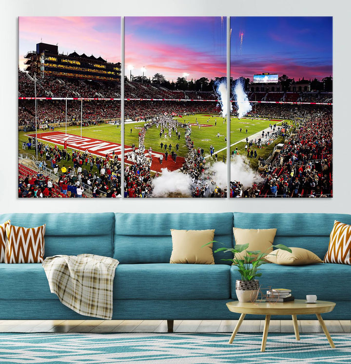 The wall art features a canvas print of the Stanford Cardinal football team, capturing players, fireworks, and smoke against the backdrop of a sunset at Stanford Stadium.