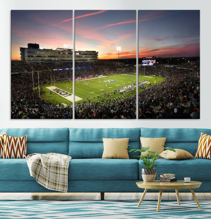 This wall art canvas print captures UCONN Huskies fans energizing a sunset scene at East Hartfords Pratt & Whitney Stadium.