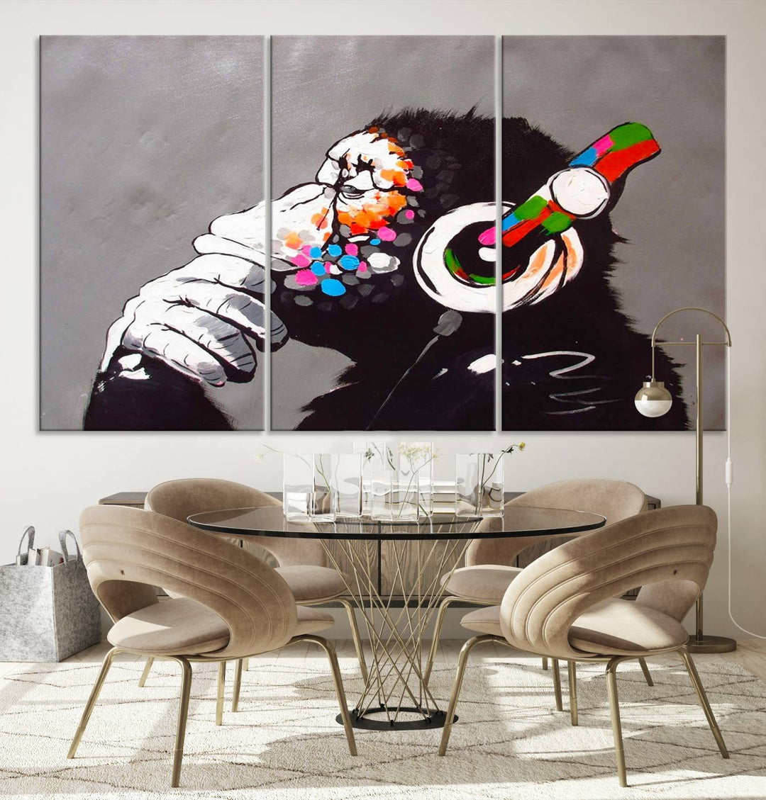 A vibrant triptych, the "DJ Monkey Listening to Music" wall art print, features a Banksy-inspired large canvas adorned with colorful modern pop art. This striking piece elegantly enhances the room with its dynamic and lively depiction.