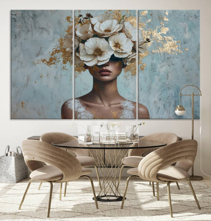 The Golden Petal Silhouette Woman Wall Art Canvas Print, a large 3-panel canvas with a textured gold floral design, serves as a luxurious centerpiece in modern glam settings. The artwork depicts a woman with flowers over her eyes against a textured background and hangs elegantly.