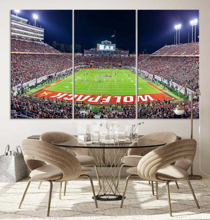 A NC State Wolfpack Football Team print of Carter-Finley Stadium at night features WOLFPACK illuminated brightly in the end zone grass.