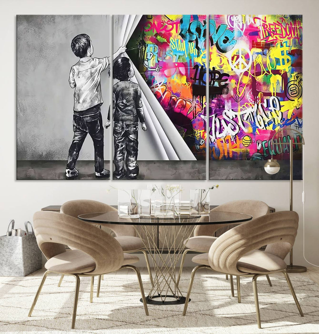 The Banksy Print - Street Art Canvas features a vibrant and bold image of two children lifting a curtain to reveal colorful graffiti. It's ready to hang, adding an urban modern decor vibe.