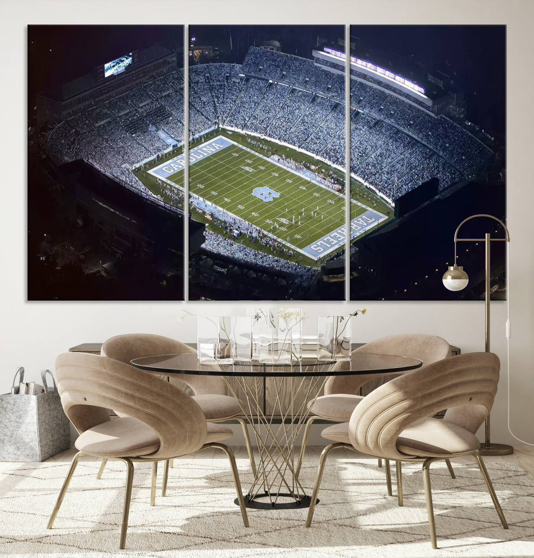 A University of North Carolina Tar Heels Football Team Print, showcasing Chapel Hill's Kenan Memorial Stadium, hangs in a modern dining room, adding a gallery-quality finish that enhances the entire space.