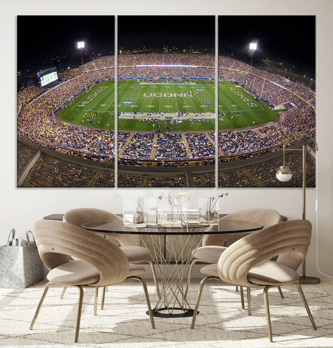 A large football stadium at night, featuring the UCONN Huskies, is depicted on the East Hartford Pratt & Whitney Stadium Wall Art Canvas Print.