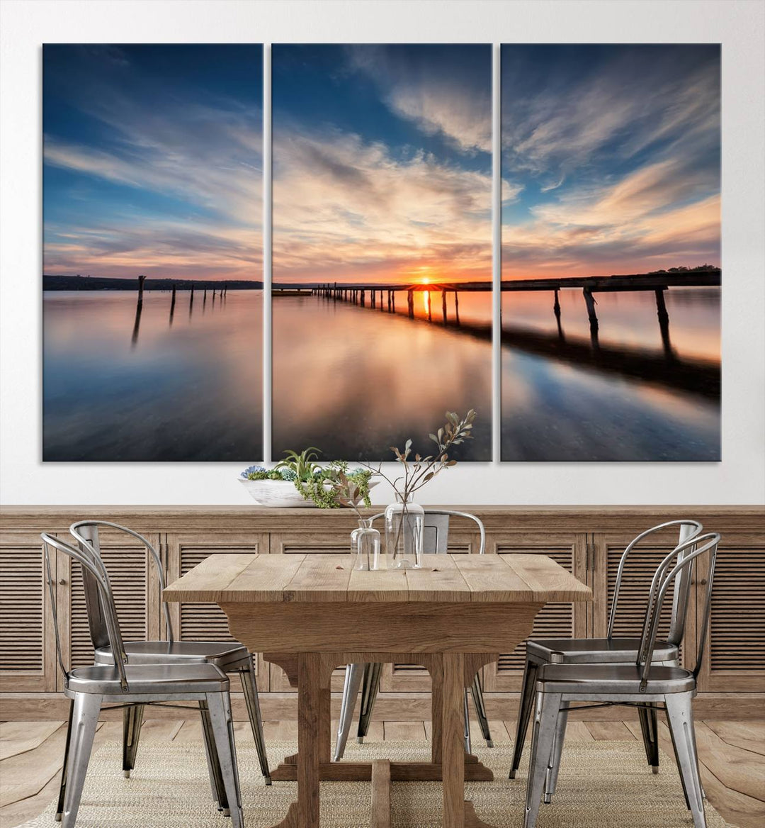 The Sunset Pier Canvas features a serene coastal landscape with vibrant hues under cloudy skies, ideal for modern decor.