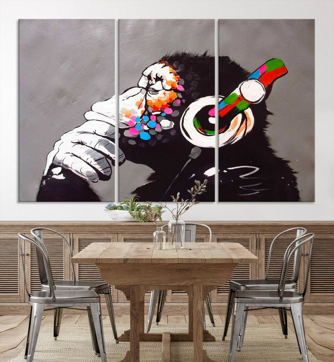 A vibrant triptych, the "DJ Monkey Listening to Music" wall art print, features a Banksy-inspired large canvas adorned with colorful modern pop art. This striking piece elegantly enhances the room with its dynamic and lively depiction.