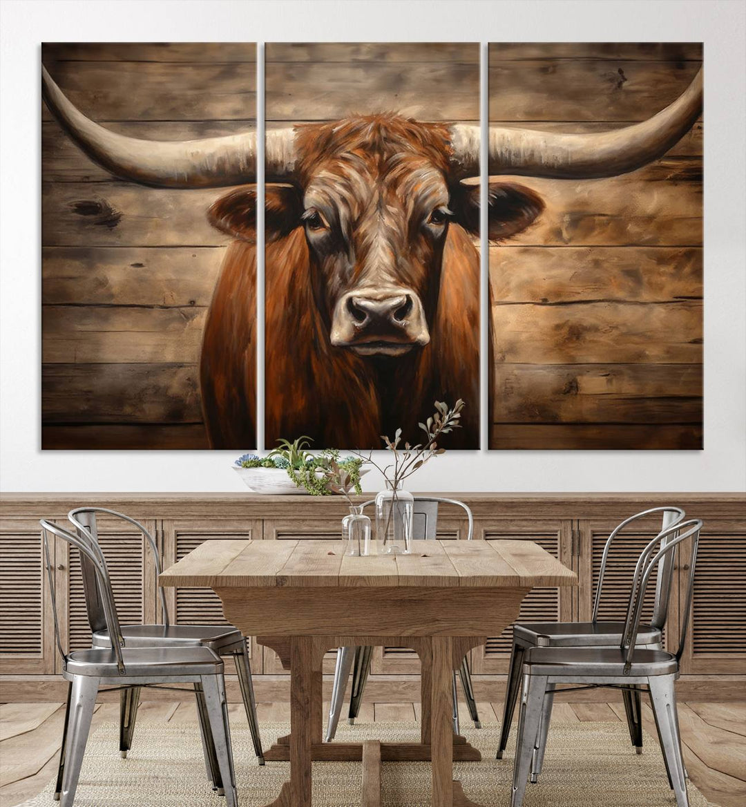 The Longhorn Bull Wall Art, a ready-to-hang canvas print, showcases an image of a brown longhorn cow set against a wooden background, perfect for those looking to enhance their space with rustic farmhouse and western barn decor.