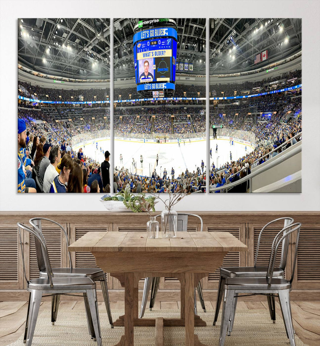 Wall art prints depicting the bustling scenes of the St. Louis Blues being cheered on by a full house at the Enterprise Center, beneath a large scoreboard.