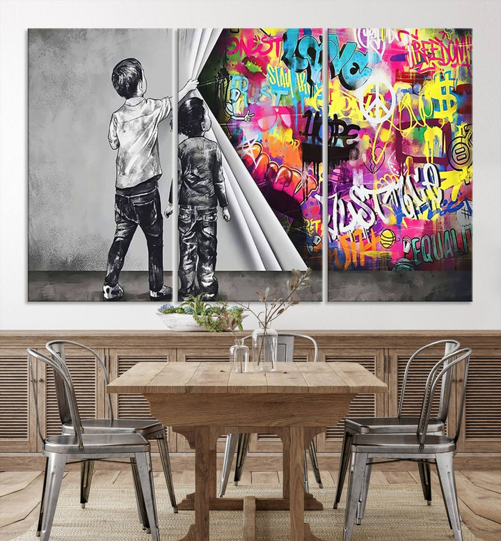 The Banksy Print - Street Art Canvas features a vibrant and bold image of two children lifting a curtain to reveal colorful graffiti. It's ready to hang, adding an urban modern decor vibe.