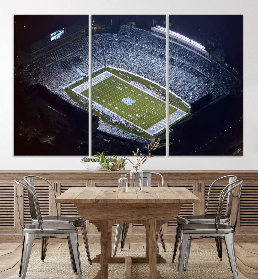 A University of North Carolina Tar Heels Football Team Print, showcasing Chapel Hill's Kenan Memorial Stadium, hangs in a modern dining room, adding a gallery-quality finish that enhances the entire space.