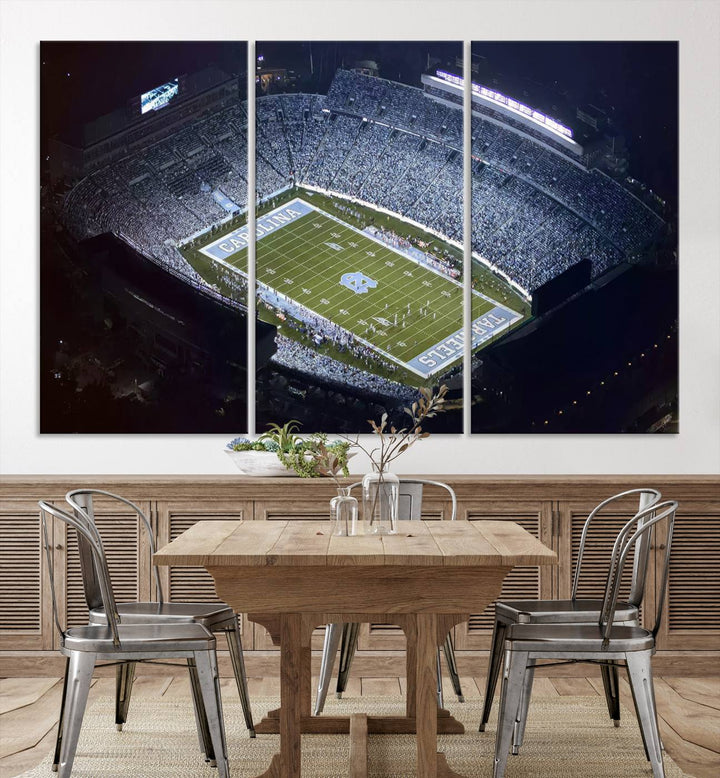 A University of North Carolina Tar Heels Football Team Print, showcasing Chapel Hill's Kenan Memorial Stadium, hangs in a modern dining room, adding a gallery-quality finish that enhances the entire space.