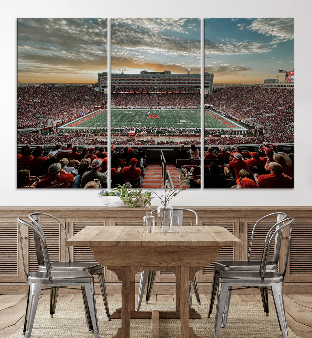 The living room features a stunning triptych of Lincoln Memorial Stadium wall art canvas print, celebrating the University of Nebraska Cornhuskers football team. This piece serves as captivating wall art, showcasing a gallery-quality finish.