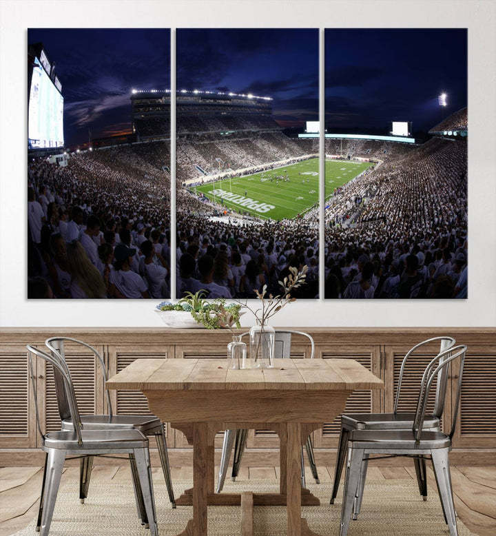 A packed football stadium at night, with bright lights and fans in white, depicted in a Michigan State Spartans Stadium wall art.