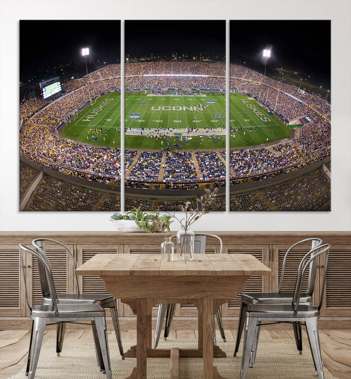 A large football stadium at night, featuring the UCONN Huskies, is depicted on the East Hartford Pratt & Whitney Stadium Wall Art Canvas Print.