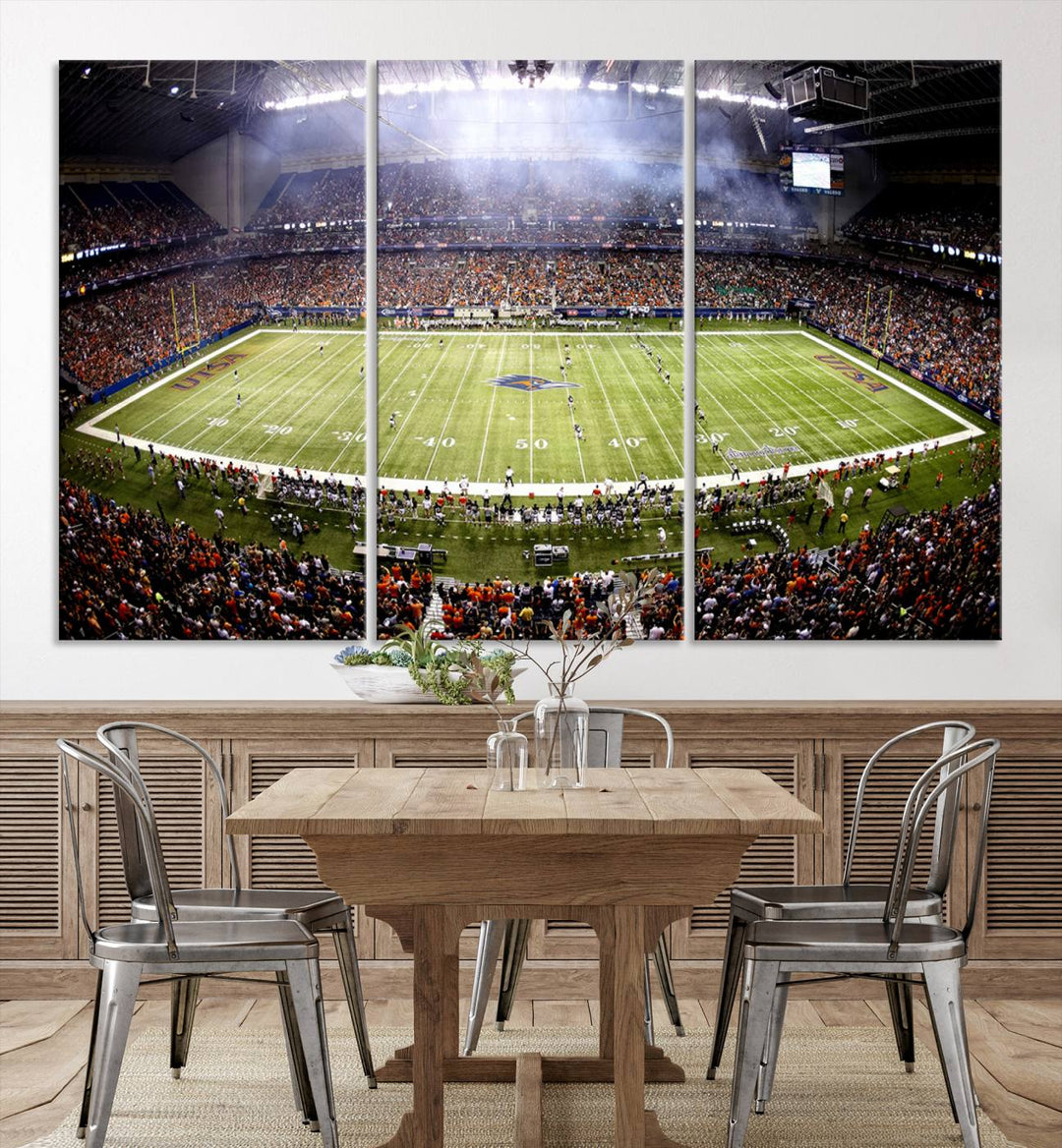 The modern living room features an Alamodome wall art canvas print, depicting a stadium filled with spectators for a UTSA Roadrunners game.