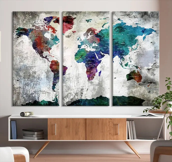 A three-panel World Map Wall Art Canvas Print, crafted with museum-quality materials, adorns the wall.