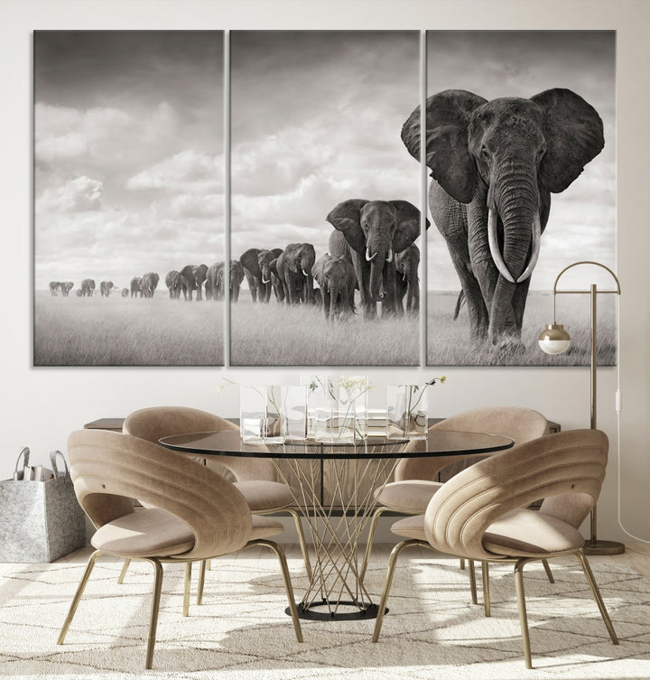 The "Herd of Elephants Wall Art Canvas Print" features an elegant black and white triptych of elephants walking in a line, beautifully displayed on museum-quality canvas with a UV-protective coating. This artwork arrives ready to hang and adds sophistication to any space.