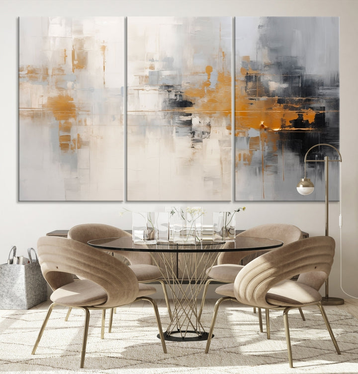 The Orange Pastel Abstract Wall Art Canvas Print, featuring a triptych of orange, white, and black hues, is elegantly displayed on museum-quality canvas.