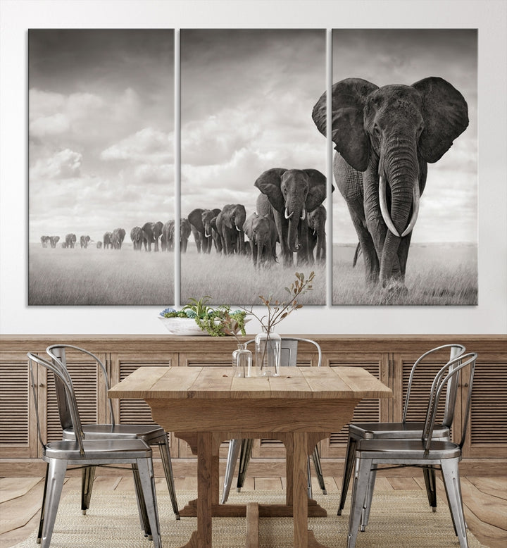 The "Herd of Elephants Wall Art Canvas Print" features an elegant black and white triptych of elephants walking in a line, beautifully displayed on museum-quality canvas with a UV-protective coating. This artwork arrives ready to hang and adds sophistication to any space.