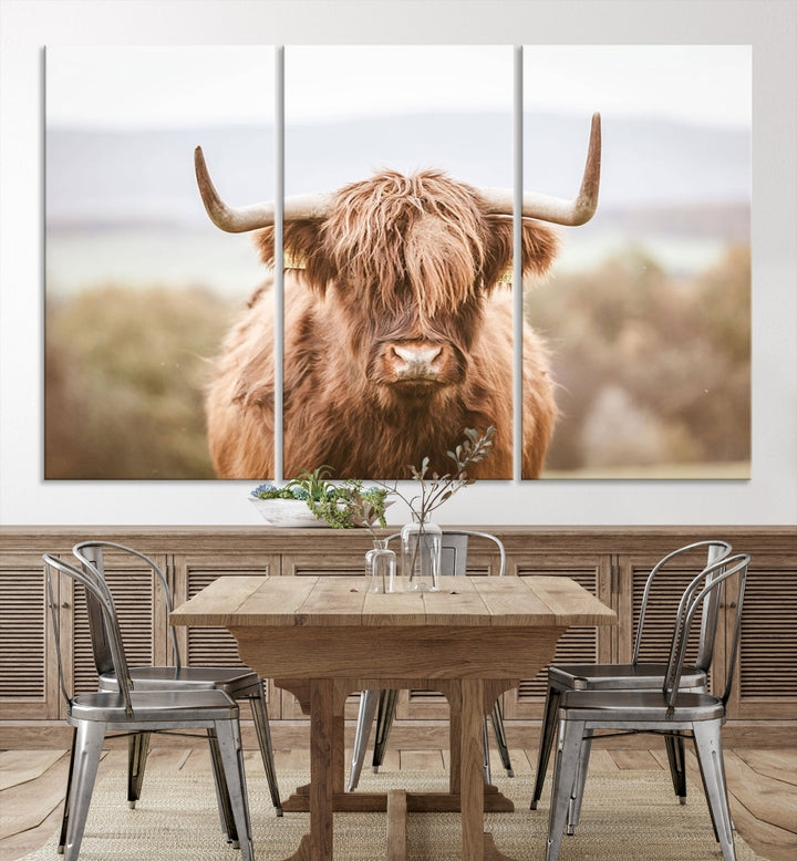 The Scottish Highland Cow Canvas Wall Art features a serene depiction of a Highland cow in natural pastel tones, adding an elegant touch to the farmhouse-inspired decor.