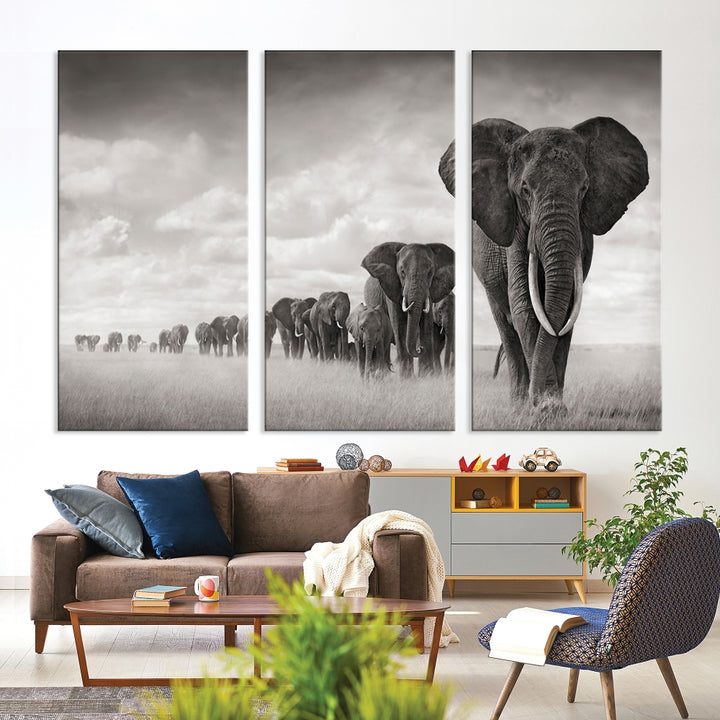 The "Herd of Elephants Wall Art Canvas Print" features an elegant black and white triptych of elephants walking in a line, beautifully displayed on museum-quality canvas with a UV-protective coating. This artwork arrives ready to hang and adds sophistication to any space.