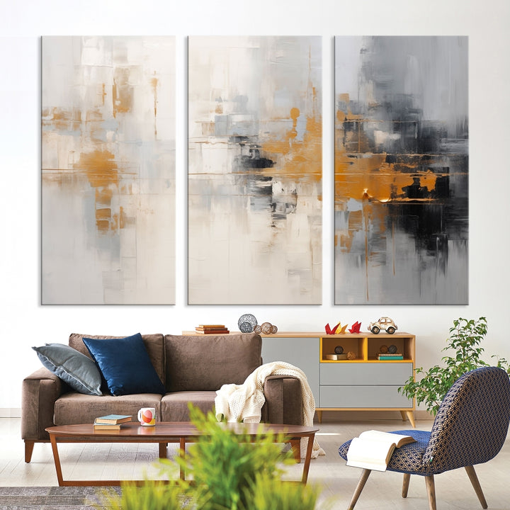 The Orange Pastel Abstract Wall Art Canvas Print, featuring a triptych of orange, white, and black hues, is elegantly displayed on museum-quality canvas.