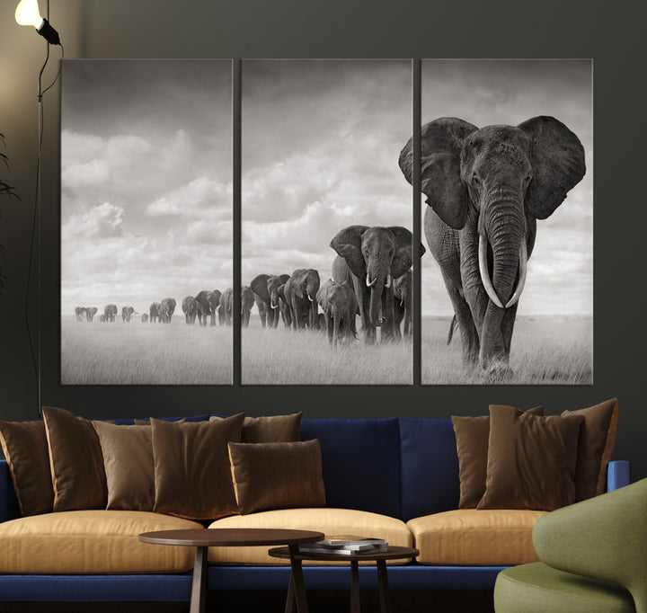 The Elephant Wall Art Canvas Print features a triptych of elephants in a savanna, elegantly displayed.